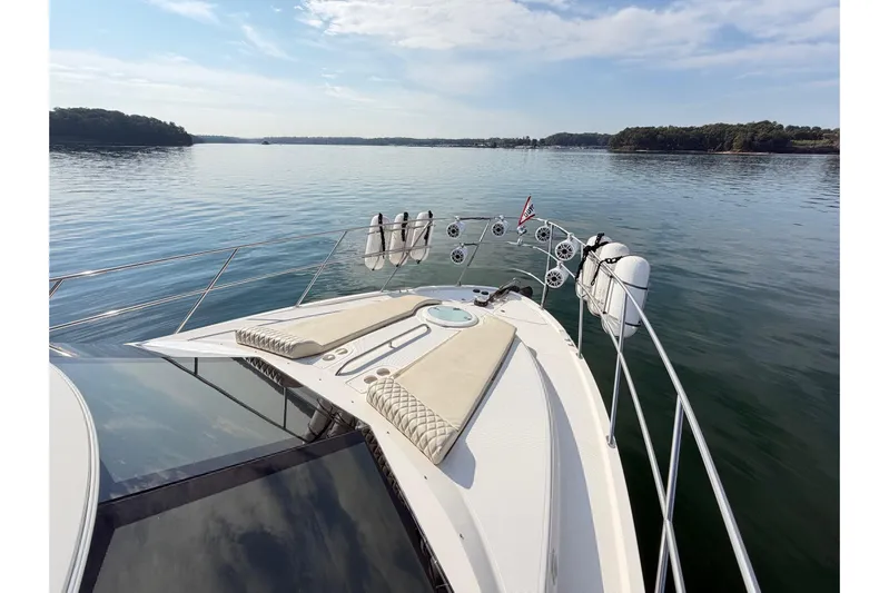 This Bar Yacht Photos Pics 2004 Meridian 459 Motoryacht on calm water, featuring spacious deck and scenic view.