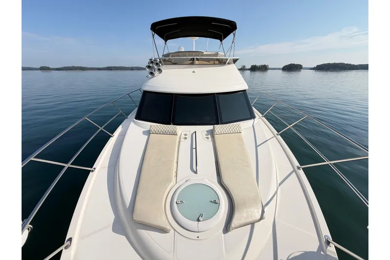 This Bar Yacht Photos Pics 2004 Meridian 459 Motoryacht on calm water, featuring spacious deck and sleek design.