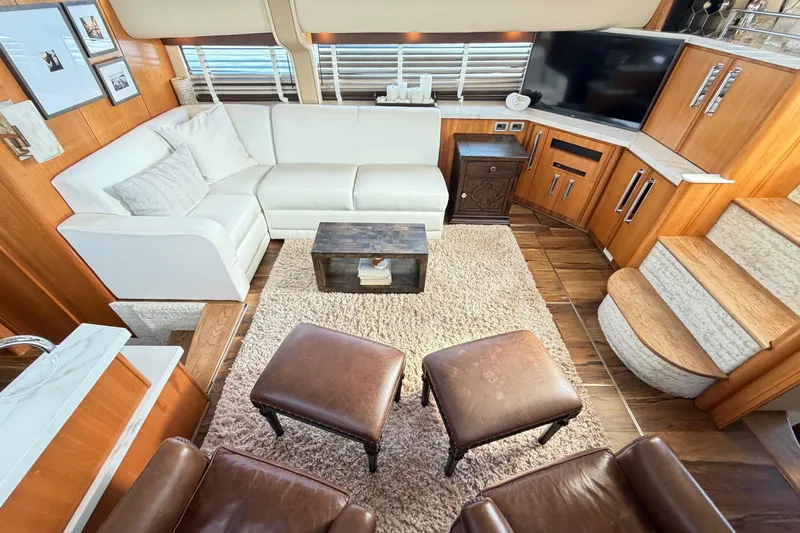 This Bar Yacht Photos Pics Luxurious interior of 2004 Meridian 459 Motoryacht with white sofa, wooden accents, and modern decor.