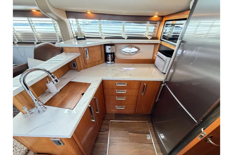 This Bar Yacht Photos Pics Luxurious 2004 Meridian 459 Motoryacht kitchen with modern appliances and elegant wood cabinetry.