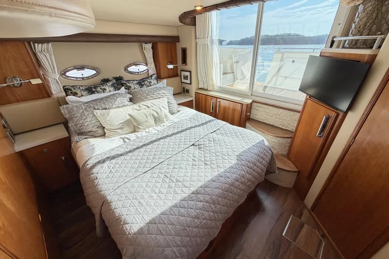 This Bar Yacht Photos Pics Luxurious bedroom interior of 2004 Meridian 459 Motoryacht with scenic window view.