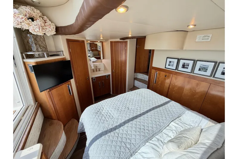 This Bar Yacht Photos Pics Luxurious interior of 2004 Meridian 459 Motoryacht with cozy bedroom and elegant decor.