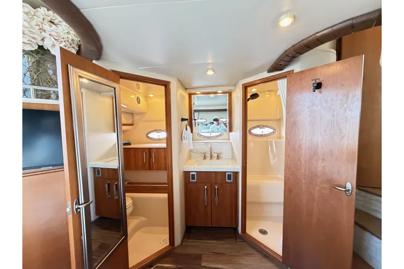 This Bar Yacht Photos Pics Luxurious bathroom interior of 2004 Meridian 459 Motoryacht with wood accents and modern fixtures.