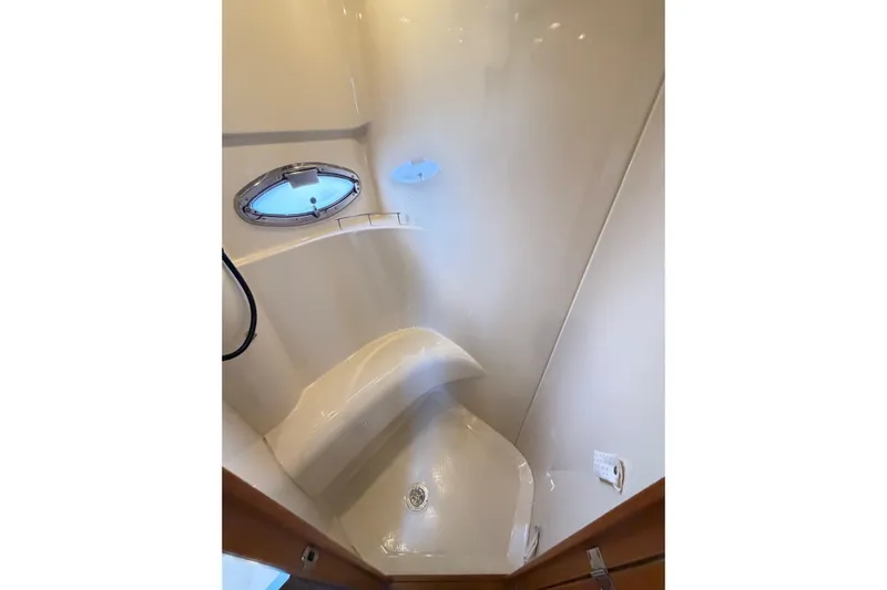 This Bar Yacht Photos Pics Shower area in 2004 Meridian 459 Motoryacht with porthole and sleek design.
