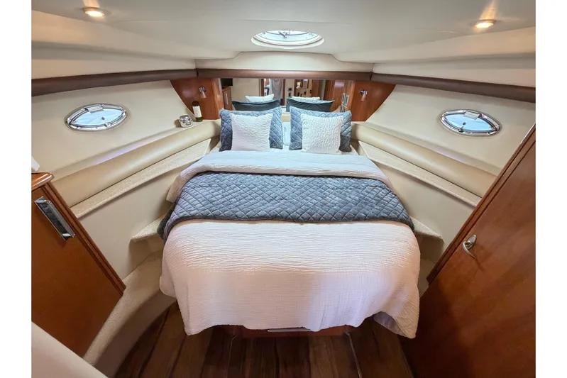 This Bar Yacht Photos Pics Luxurious bedroom interior of 2004 Meridian 459 Motoryacht with elegant bedding and porthole windows.