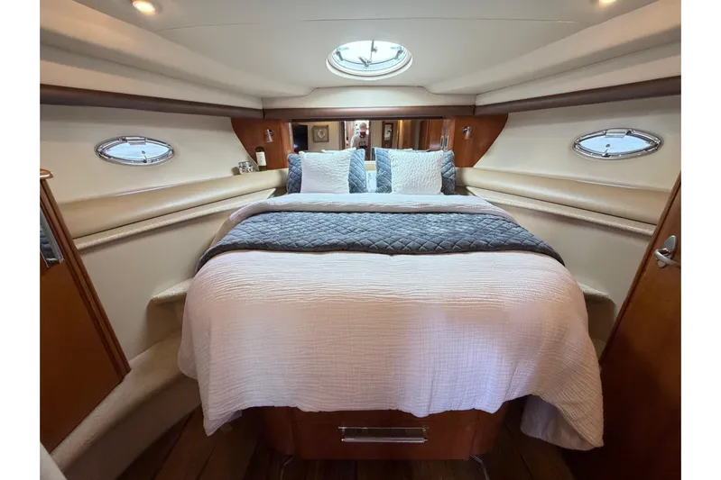 This Bar Yacht Photos Pics Luxurious bedroom interior of 2004 Meridian 459 Motoryacht with elegant bedding and porthole windows.