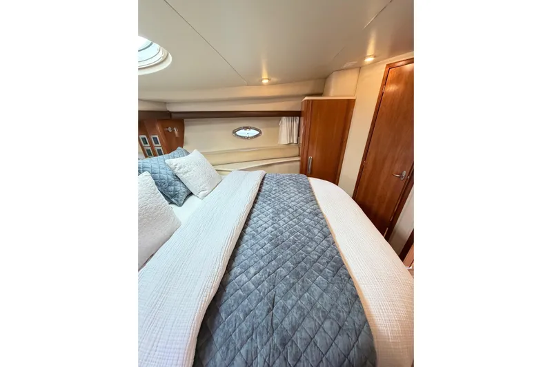 This Bar Yacht Photos Pics Luxurious bedroom interior of 2004 Meridian 459 Motoryacht with elegant bedding and wood accents.