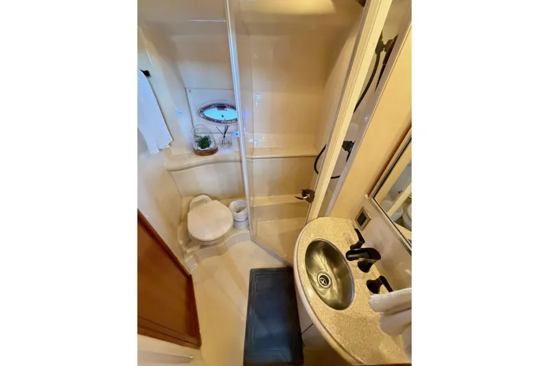 This Bar Yacht Photos Pics Bathroom interior of 2004 Meridian 459 Motoryacht with shower, sink, and toilet.