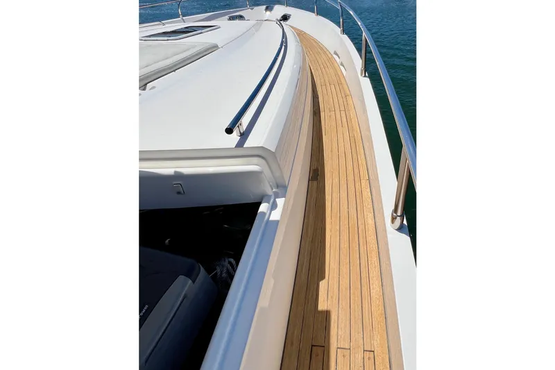  Yacht Photos Pics Deck view of 2010 Princess V78 yacht with wooden walkway and sleek design.