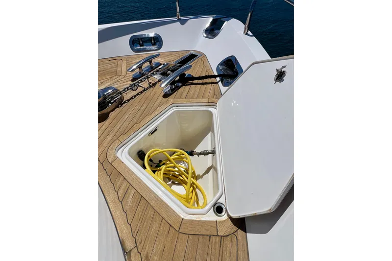  Yacht Photos Pics Open hatch on 2010 Princess V78 yacht deck with yellow hose inside.