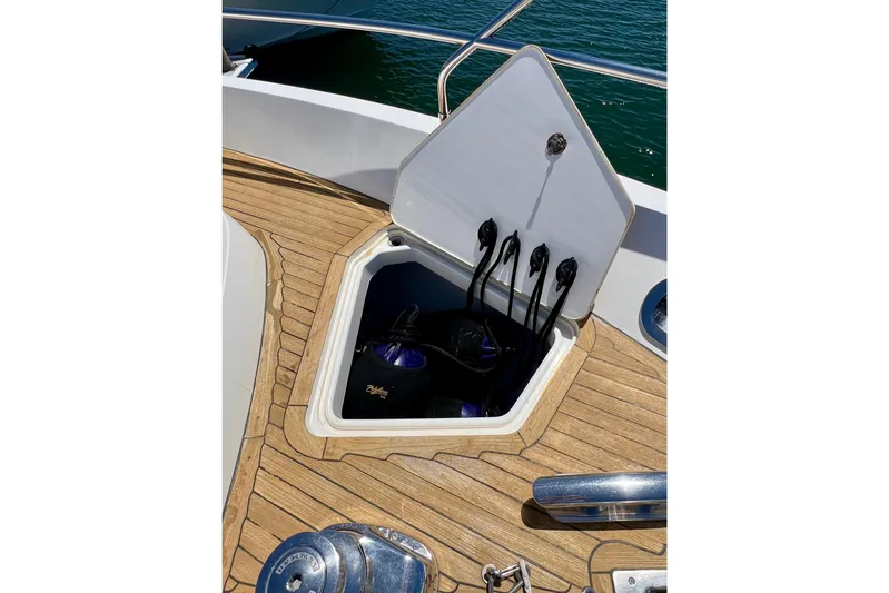  Yacht Photos Pics Open storage compartment on 2010 Princess V78 yacht deck with ropes and fenders.