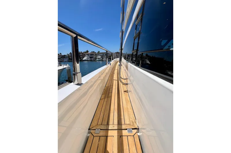  Yacht Photos Pics Side deck view of 2010 Princess V78 yacht with wooden flooring and sleek design.