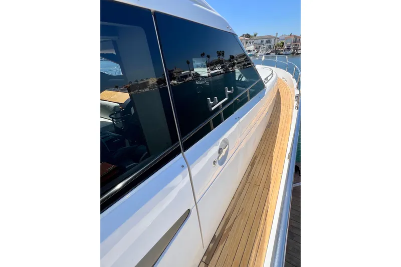  Yacht Photos Pics 2010 Princess V78 yacht with sleek design and wooden deck, docked in a marina.