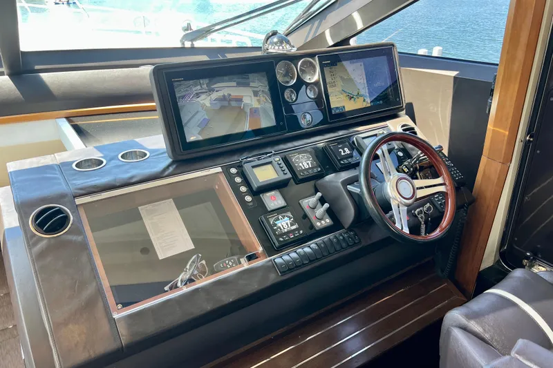  Yacht Photos Pics Cockpit of 2010 Princess V78 yacht with navigation screens and steering wheel.