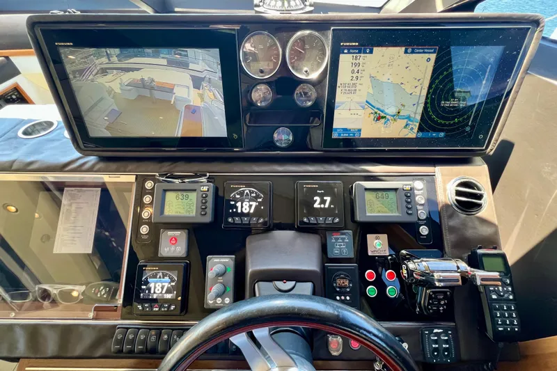  Yacht Photos Pics Control panel of a 2010 Princess V78 yacht with navigation screens and gauges.