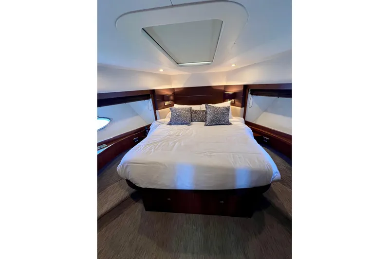  Yacht Photos Pics Luxurious bedroom interior of 2010 Princess V78 yacht with elegant bedding and ambient lighting.