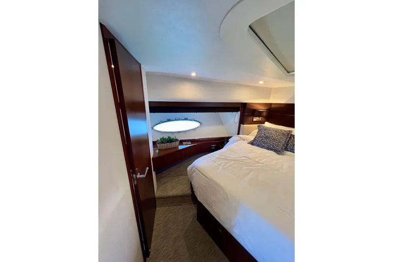  Yacht Photos Pics Luxurious bedroom interior of 2010 Princess V78 yacht with elegant wood finishes.