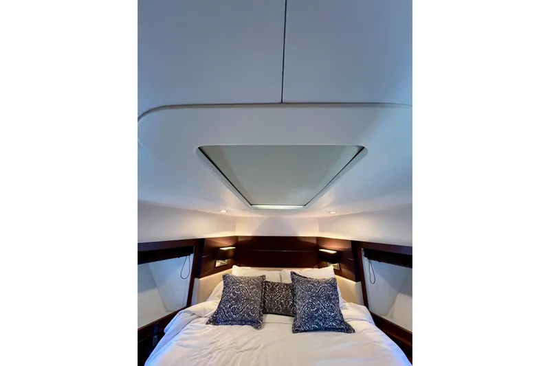  Yacht Photos Pics Luxurious bedroom interior of 2010 Princess V78 yacht with skylight and plush bedding.
