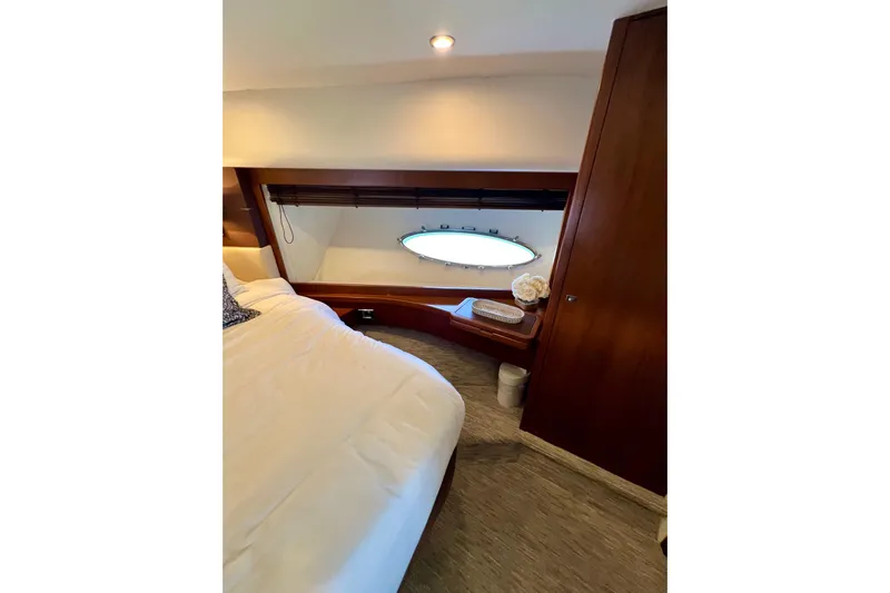  Yacht Photos Pics Luxurious cabin interior of 2010 Princess V78 yacht with elegant wood finish and porthole window.