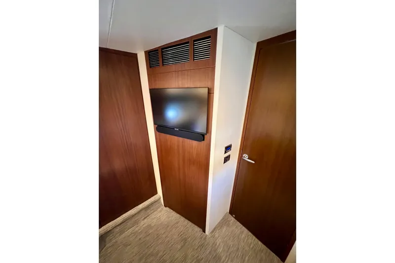  Yacht Photos Pics Interior of 2010 Princess V78 yacht with wall-mounted TV and wooden paneling.