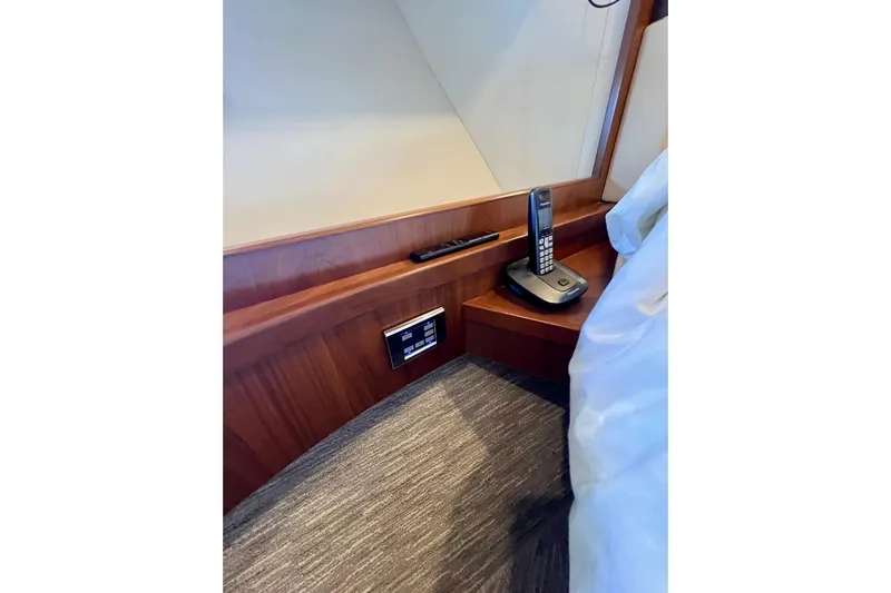  Yacht Photos Pics Interior of 2010 Princess V78 yacht with phone and control panel on wooden surface.