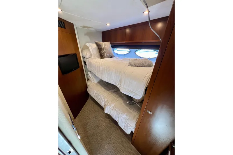  Yacht Photos Pics Luxurious 2010 Princess V78 yacht cabin with cozy bunk beds and elegant wood finishes.