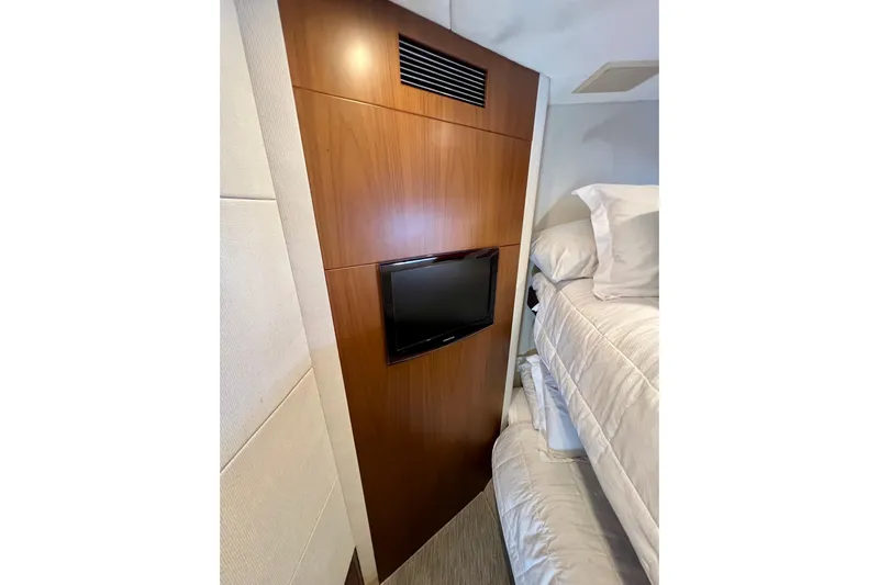  Yacht Photos Pics Luxurious 2010 Princess V78 yacht interior with wood paneling and mounted TV.