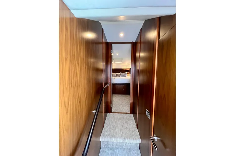  Yacht Photos Pics Hallway view inside 2010 Princess V78 yacht, featuring wooden paneling and carpeted flooring.