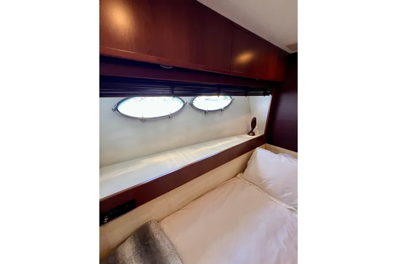  Yacht Photos Pics Luxurious cabin interior of 2010 Princess V78 yacht with porthole windows.