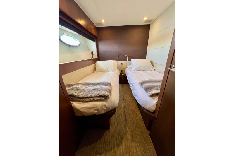  Yacht Photos Pics Luxurious twin cabin interior of 2010 Princess V78 yacht with cozy bedding.