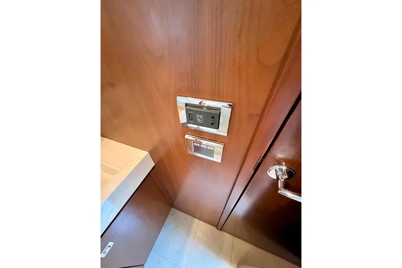  Yacht Photos Pics Wooden interior of 2010 Princess V78 yacht with control panels and door handle.