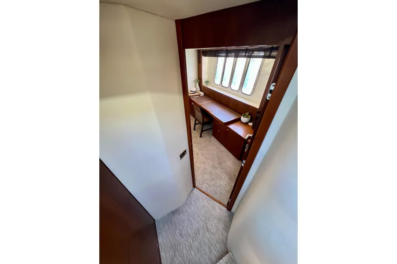  Yacht Photos Pics Interior of 2010 Princess V78 yacht, featuring a cozy cabin with desk and windows.