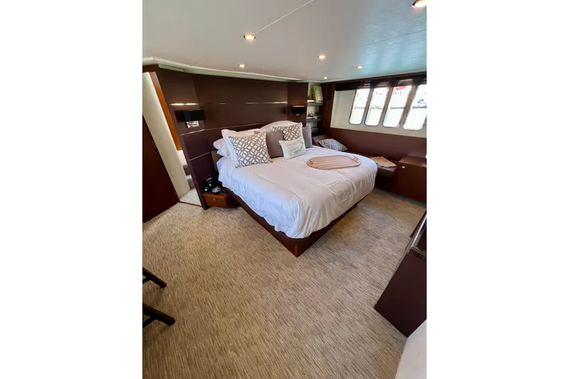  Yacht Photos Pics Luxurious bedroom interior of 2010 Princess V78 yacht with elegant decor and cozy bedding.