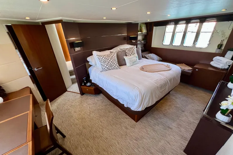  Yacht Photos Pics Luxurious bedroom interior of 2010 Princess V78 yacht with elegant decor and cozy ambiance.