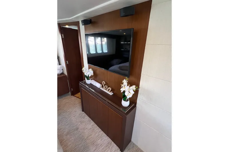 Yacht Photos Pics Luxurious interior of 2010 Princess V78 yacht with elegant decor and modern TV setup.