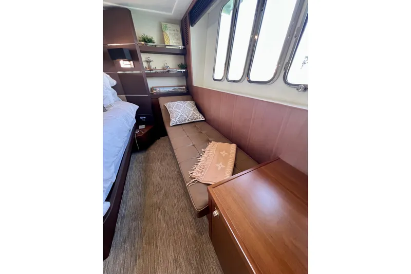  Yacht Photos Pics Luxurious cabin interior of 2010 Princess V78 yacht with cozy seating and elegant decor.