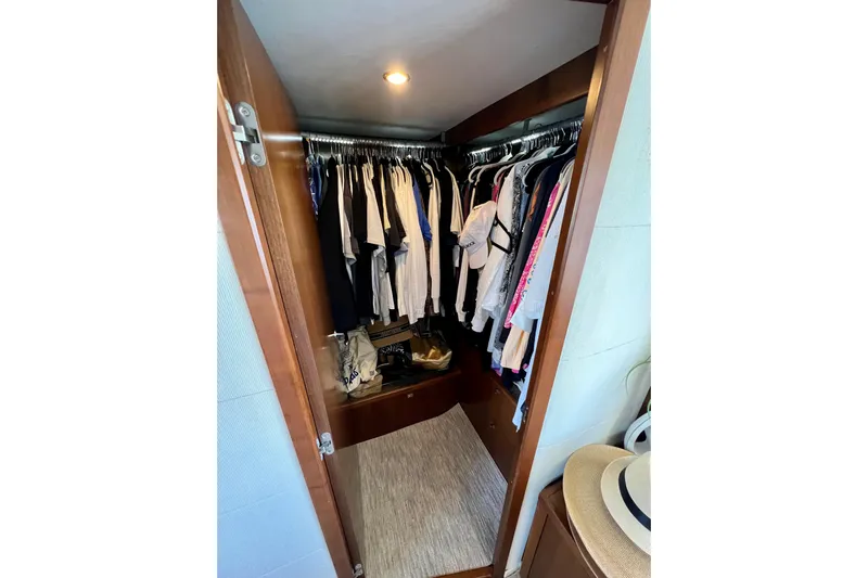  Yacht Photos Pics Closet inside 2010 Princess V78 yacht, featuring hanging clothes and accessories.