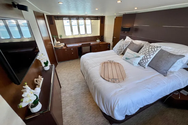  Yacht Photos Pics Luxurious bedroom interior of 2010 Princess V78 yacht with elegant decor and large windows.