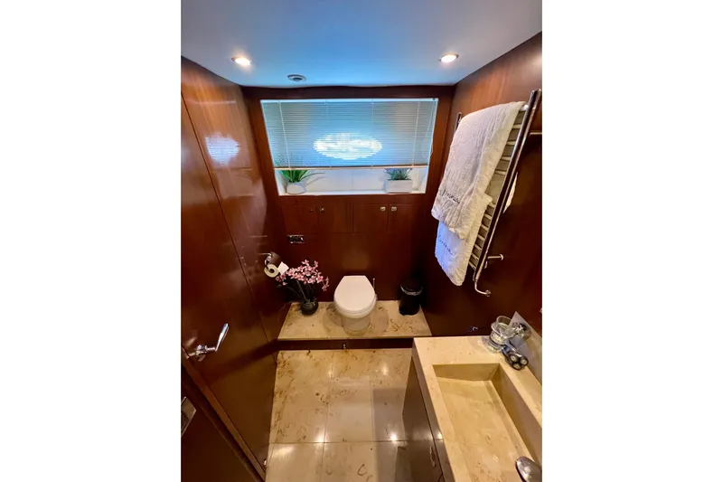  Yacht Photos Pics Luxurious bathroom in 2010 Princess V78 yacht with elegant wood paneling and modern fixtures.