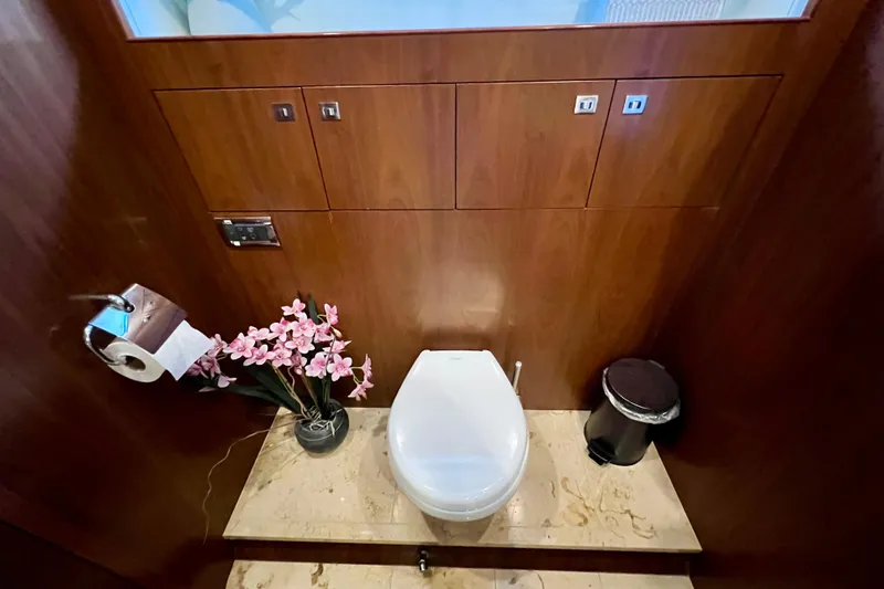  Yacht Photos Pics Luxurious yacht bathroom with wooden paneling, floral decor, and modern fixtures on a 2010 Princess V78.