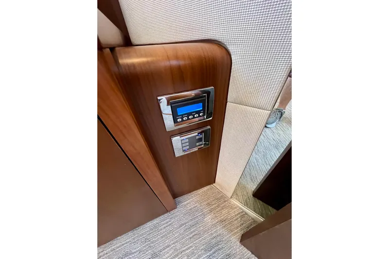  Yacht Photos Pics Control panel on 2010 Princess V78 yacht with wood finish and modern design.