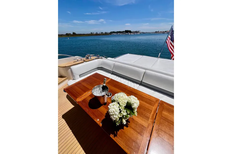  Yacht Photos Pics Luxurious 2010 Princess V78 yacht deck with flowers and champagne, overlooking serene waters.
