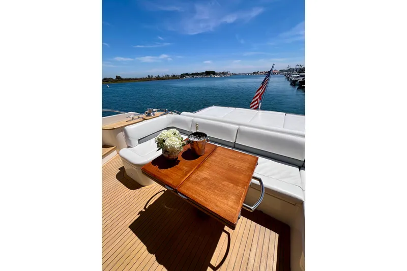  Yacht Photos Pics Luxurious 2010 Princess V78 yacht deck with elegant seating and scenic ocean view.