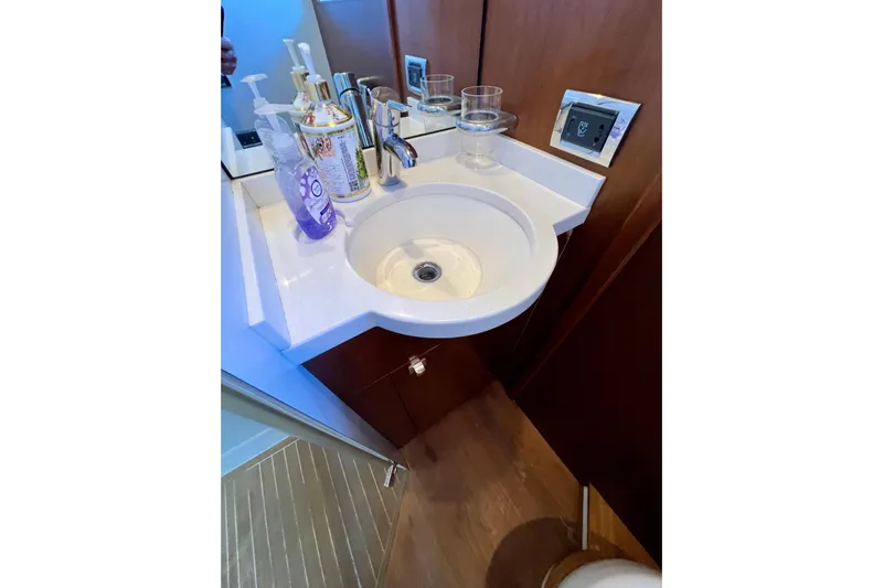  Yacht Photos Pics Luxurious bathroom sink on 2010 Princess V78 yacht with toiletries and modern fixtures.