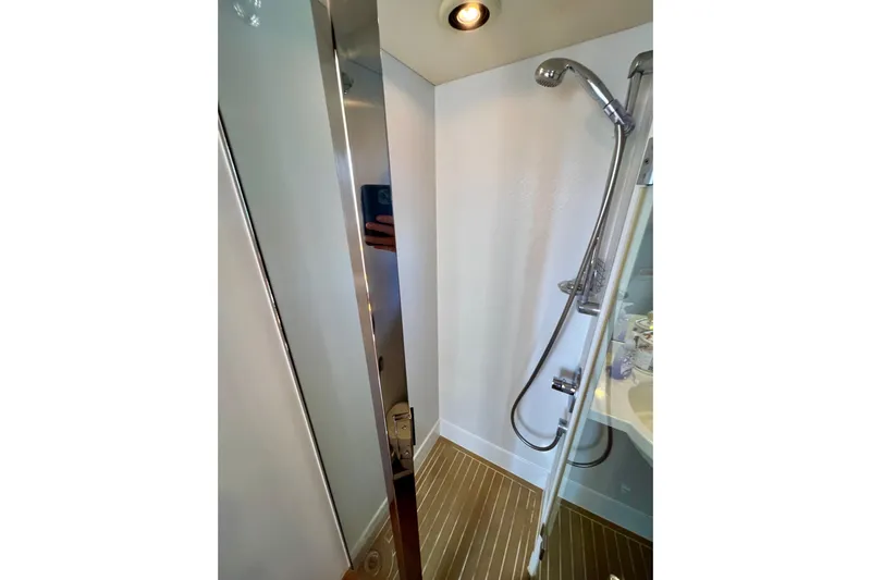  Yacht Photos Pics Shower area in 2010 Princess V78 yacht with modern fixtures and wooden flooring.
