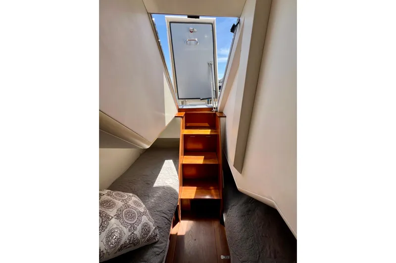  Yacht Photos Pics Interior view of 2010 Princess V78 yacht with wooden stairs and cozy bedding.