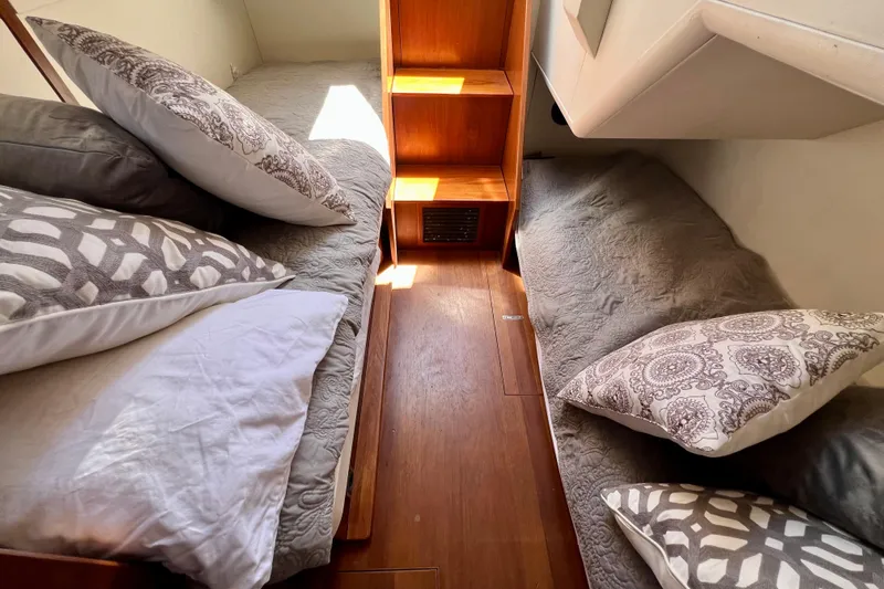  Yacht Photos Pics Cozy cabin interior of 2010 Princess V78 yacht with patterned pillows and wooden flooring.