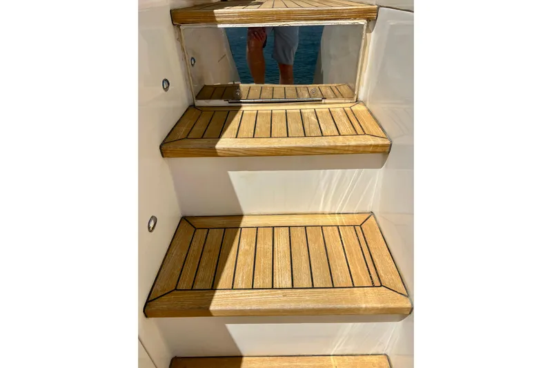  Yacht Photos Pics Wooden steps on a 2010 Princess V78 yacht, reflecting sunlight.