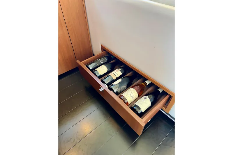  Yacht Photos Pics Drawer with wine bottles in a 2010 Princess V78 yacht interior.