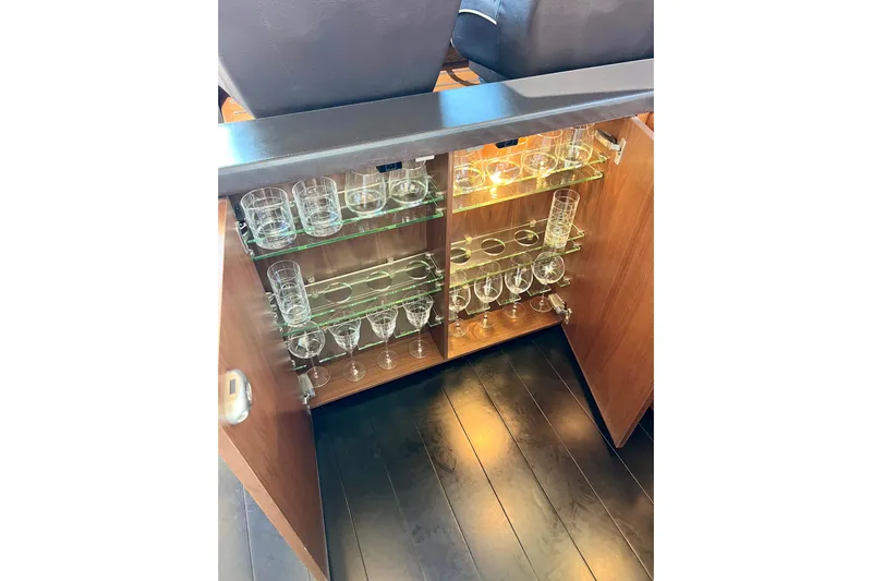  Yacht Photos Pics Glassware cabinet on 2010 Princess V78 yacht, featuring shelves with various glasses.